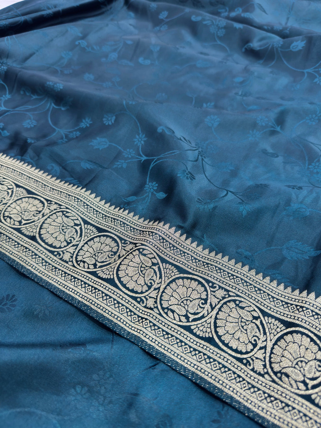 Blue fabric with intricate white embroidery