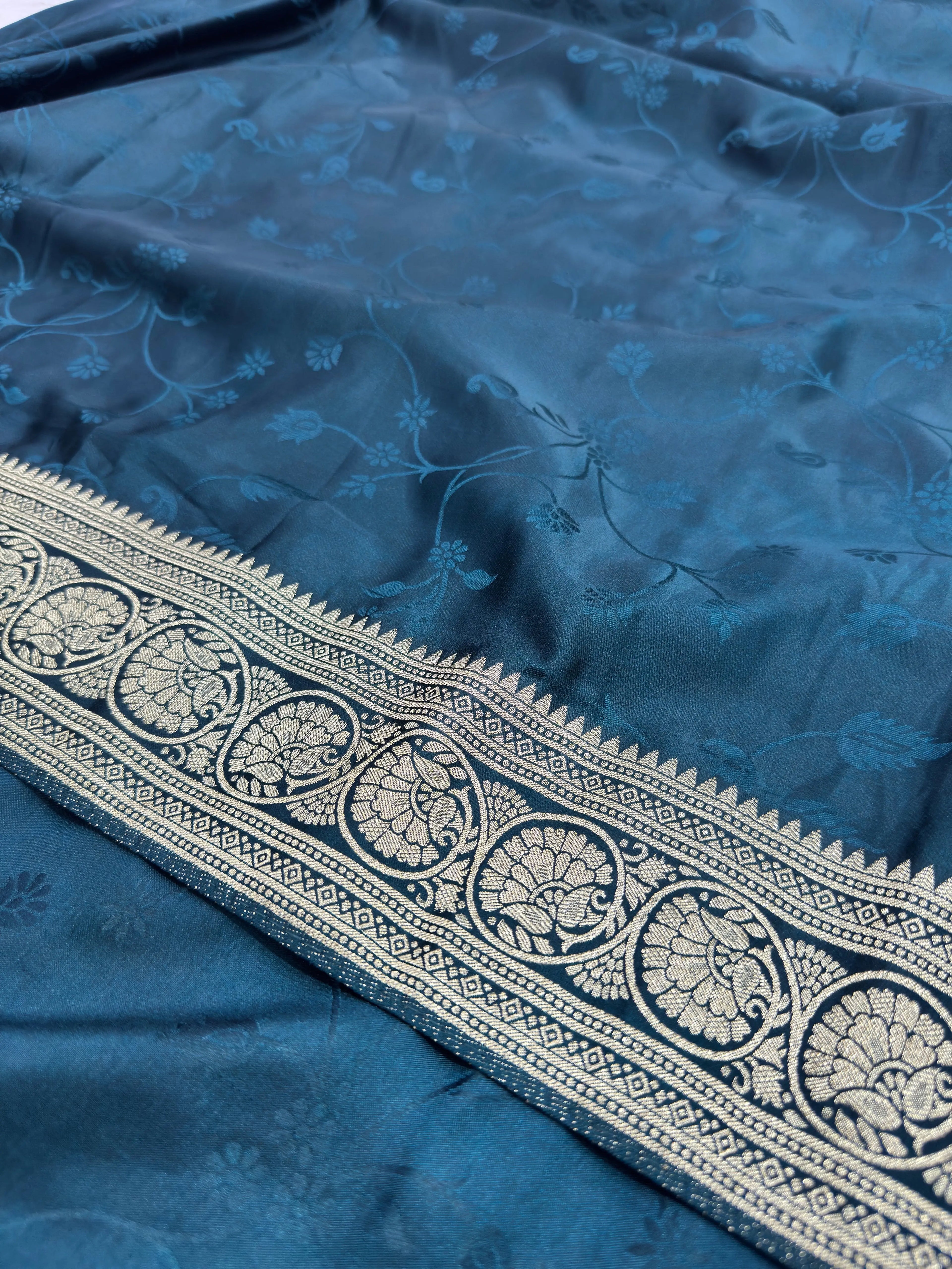 Blue fabric with intricate white embroidery