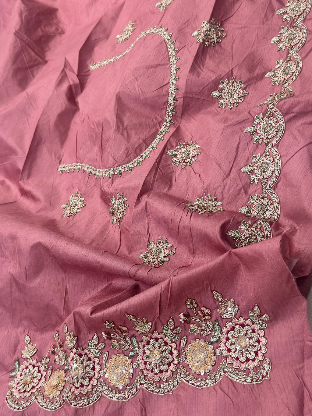 Pink fabric with intricate silver embroidery