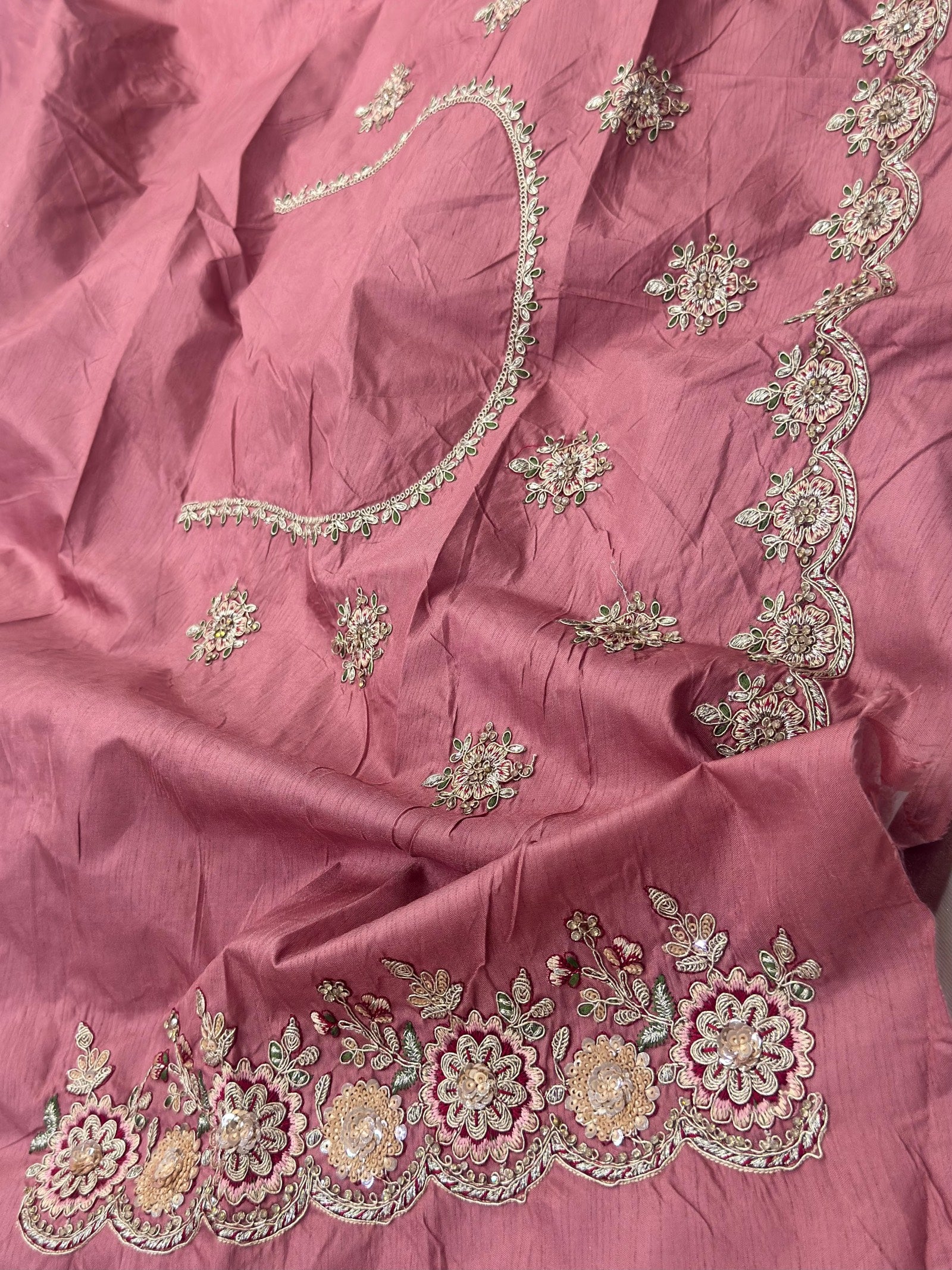 Pink fabric with intricate silver embroidery