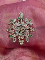 Decorative floral embroidery on a pink fabric background
