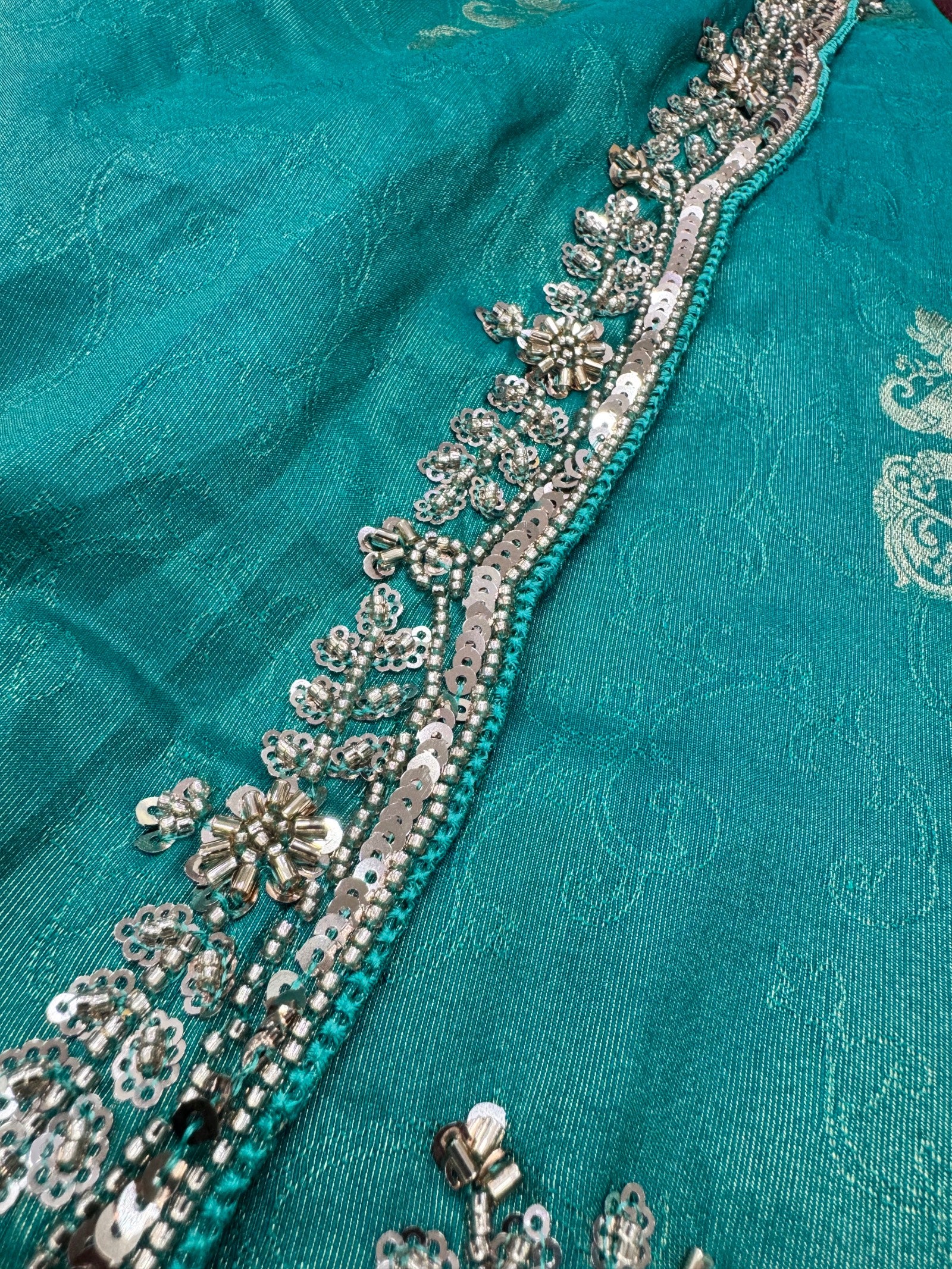 Teal fabric with silver embroidery