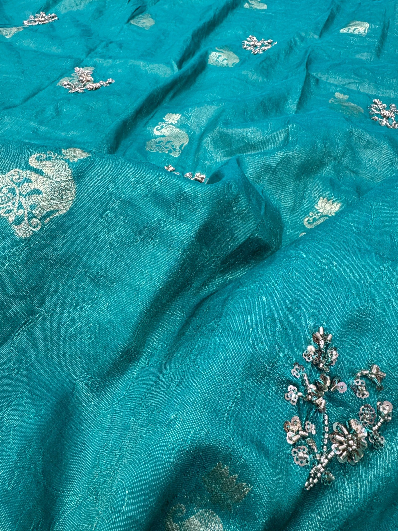 Turquoise fabric with silver floral embroidery
