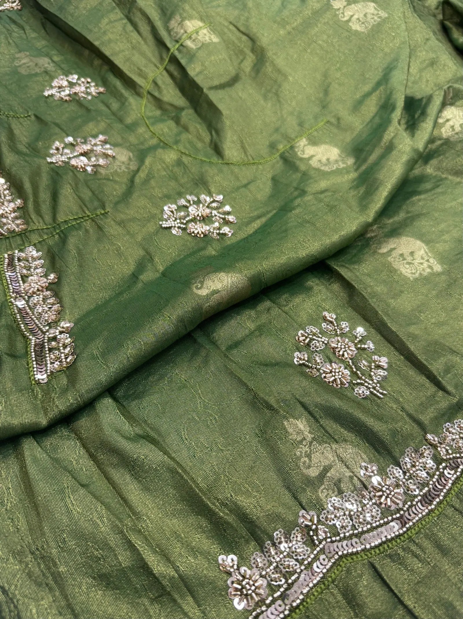 Green fabric with silver embroidery
