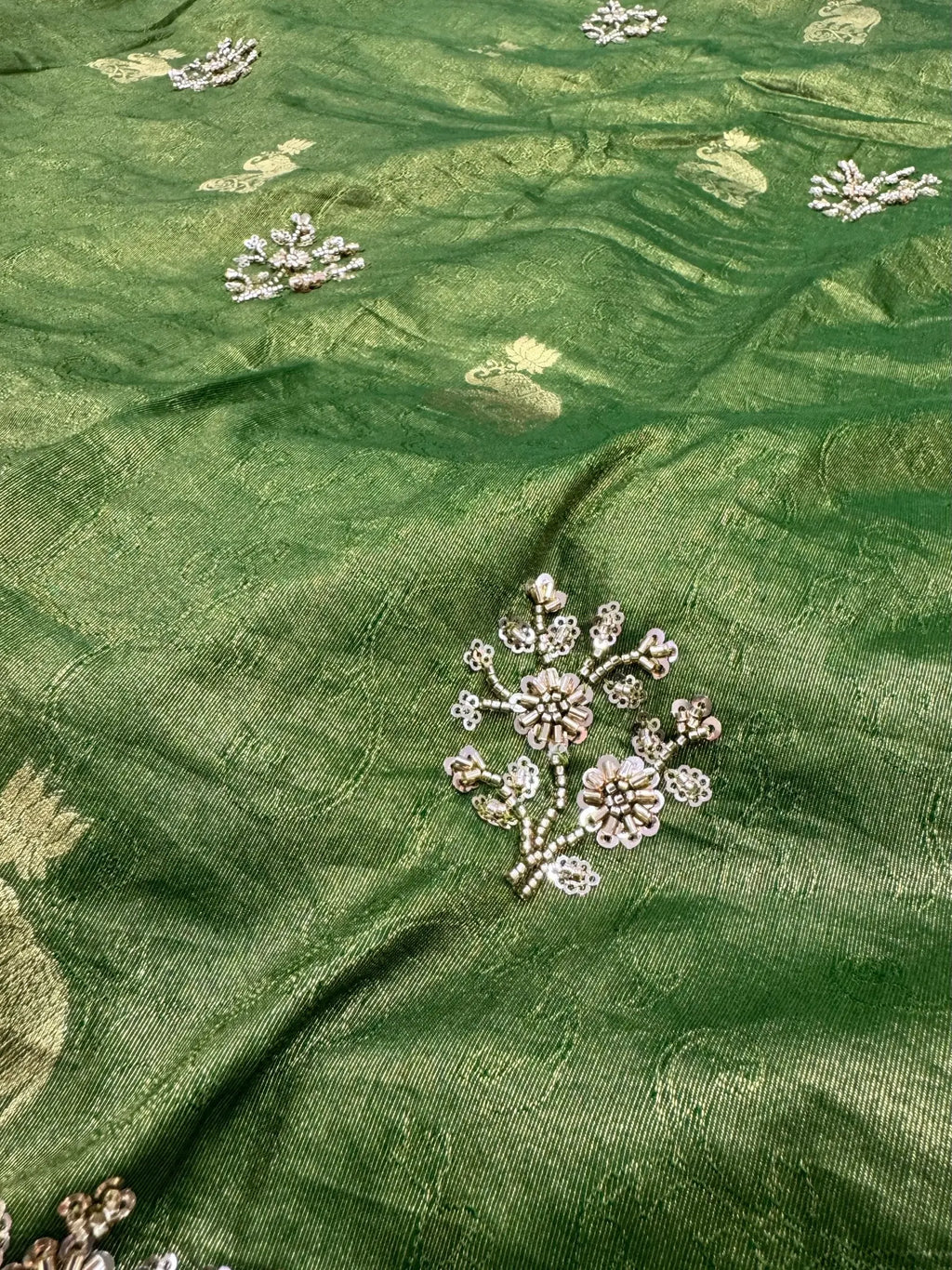 Green fabric with floral embroidery