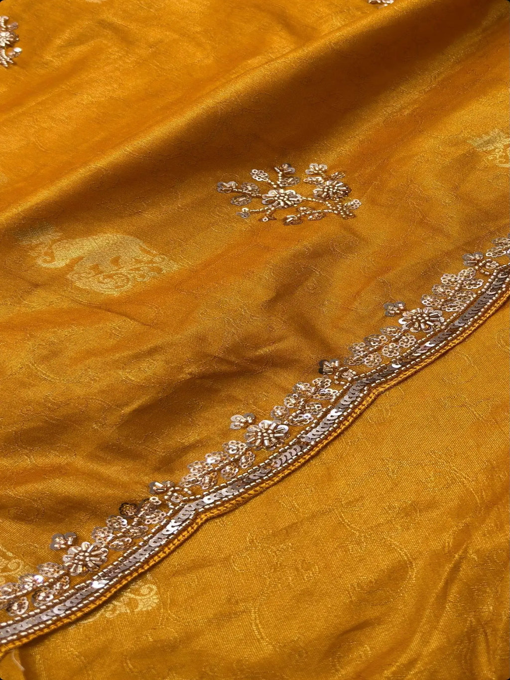 Close-up of scalloped sequin and cutdana handwork border on mustard yellow Dolla silk saree