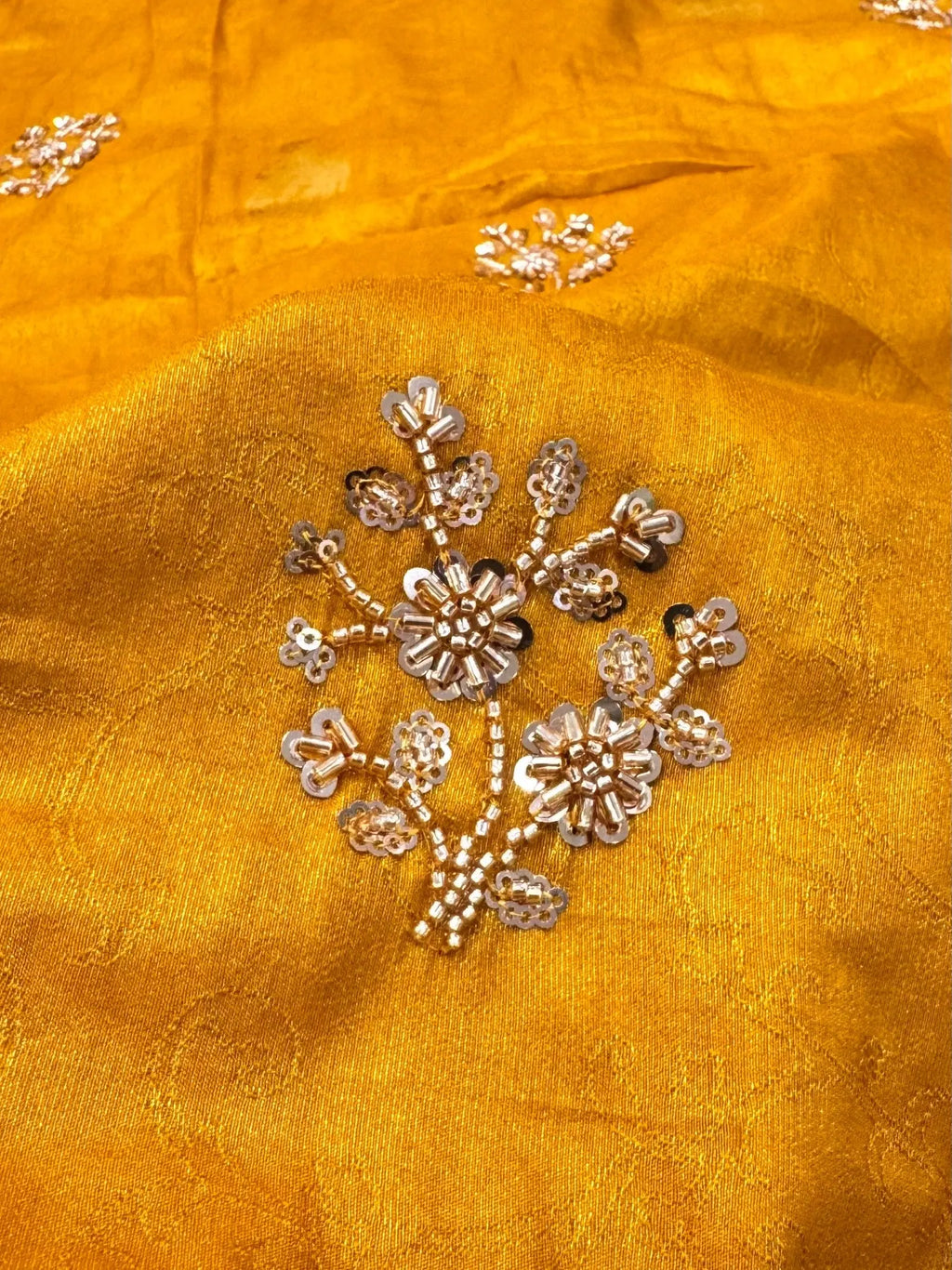Detailed hand-embroidered floral butti in cutdana and sequins on mustard yellow Dolla silk saree
