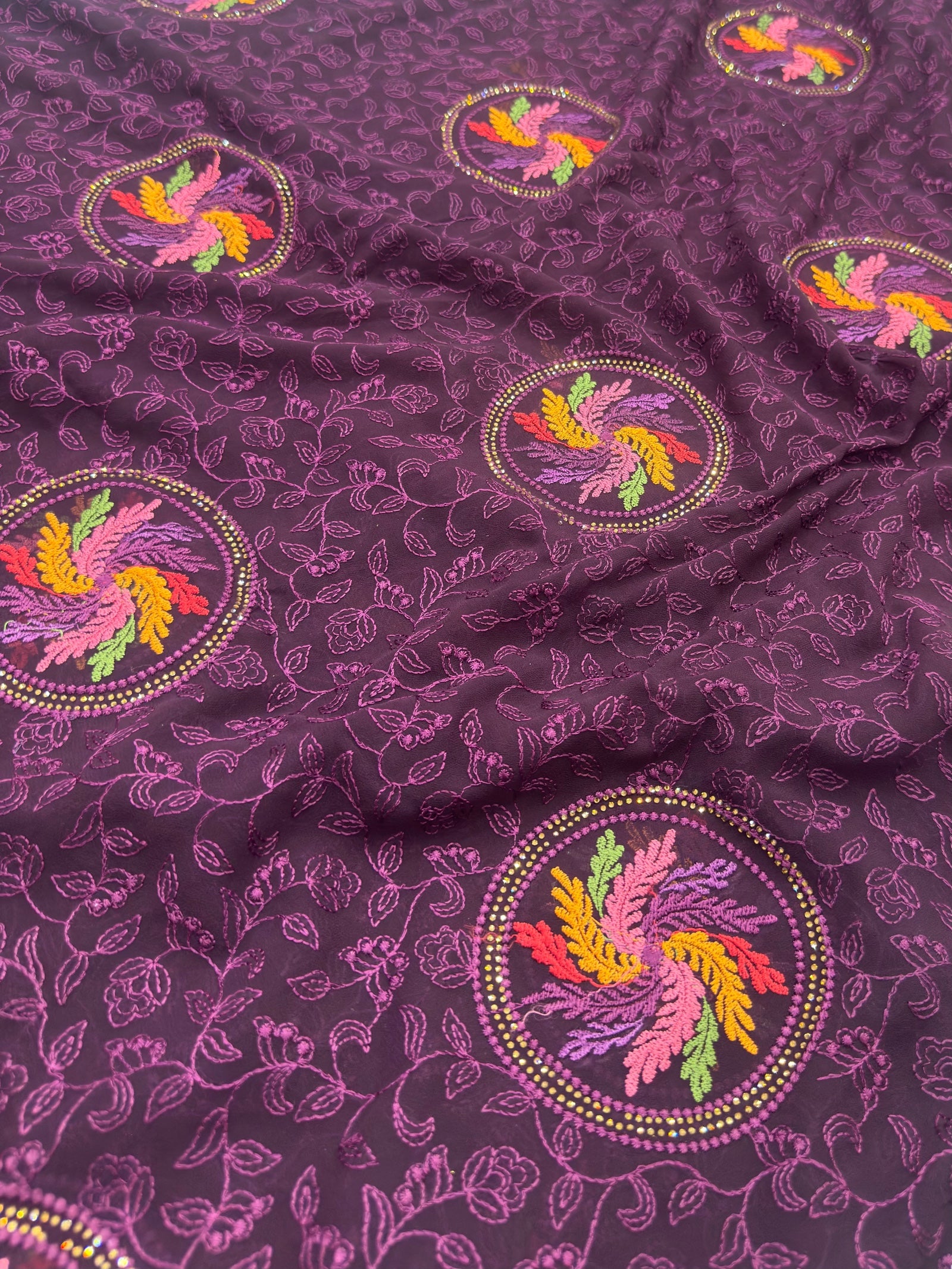 Purple fabric with colorful embroidered patterns