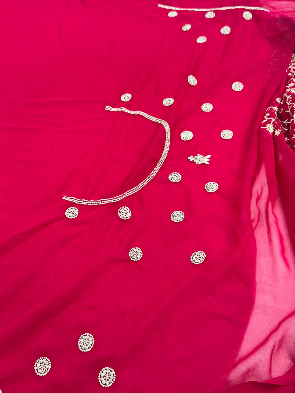 Red fabric with white embroidery details