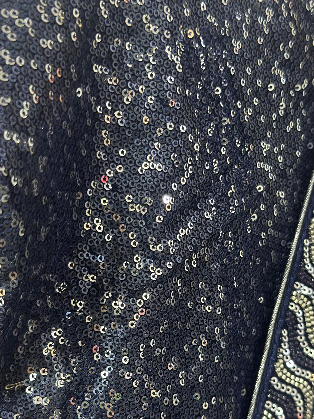 Close-up of a sequined fabric with a dark background