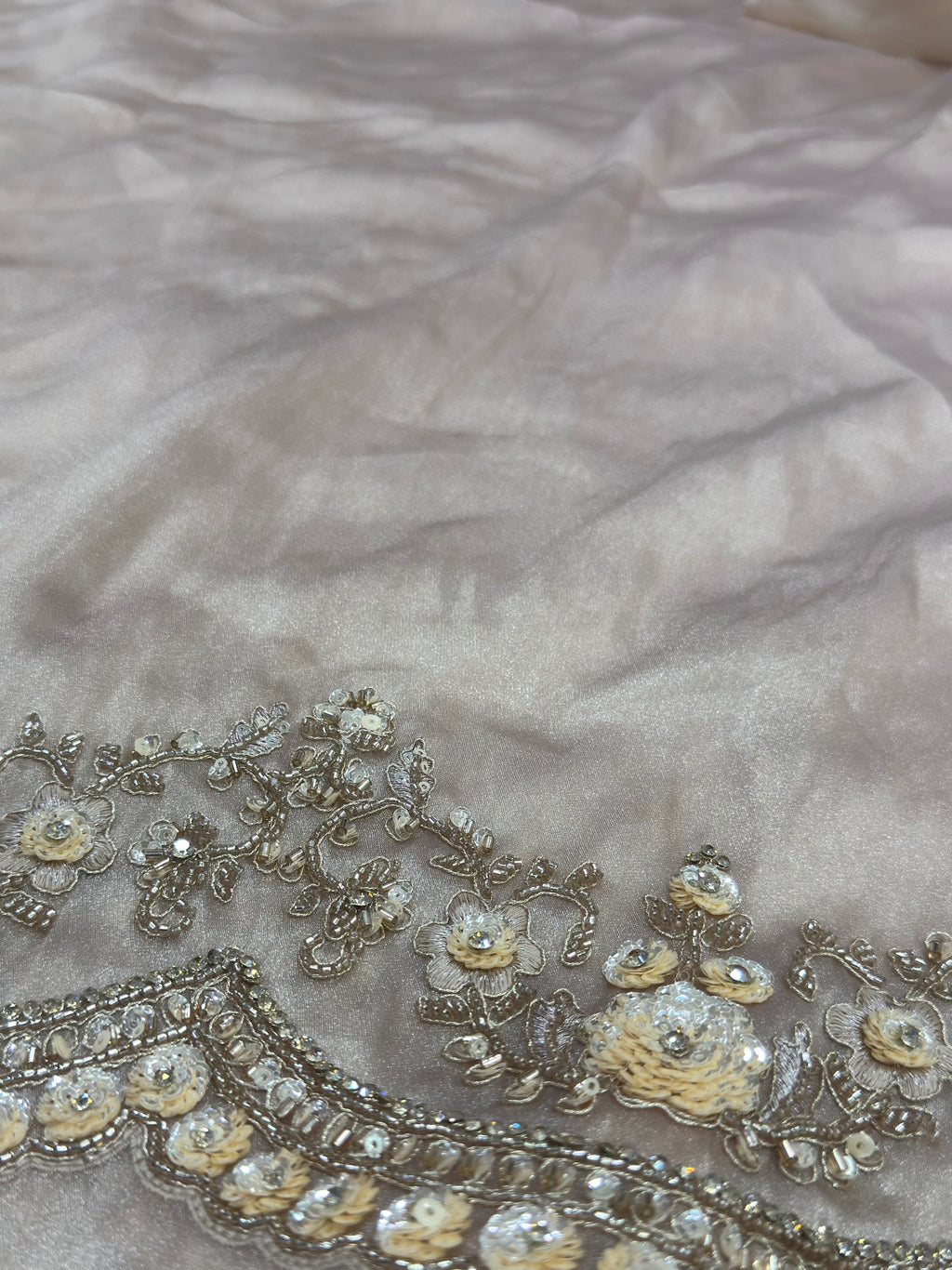 Decorative fabric with floral embroidery on a textured background