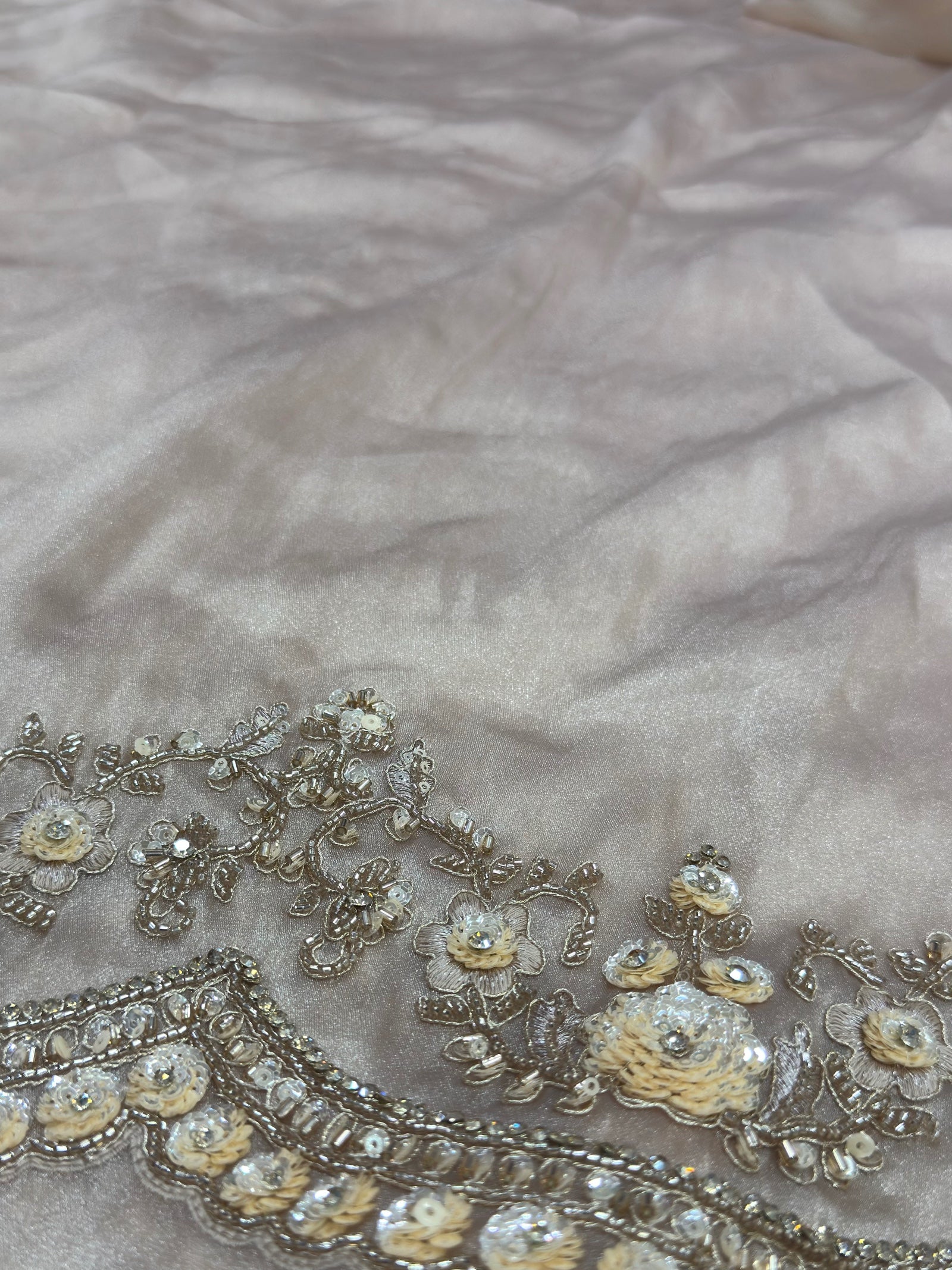 Decorative fabric with floral embroidery on a textured background