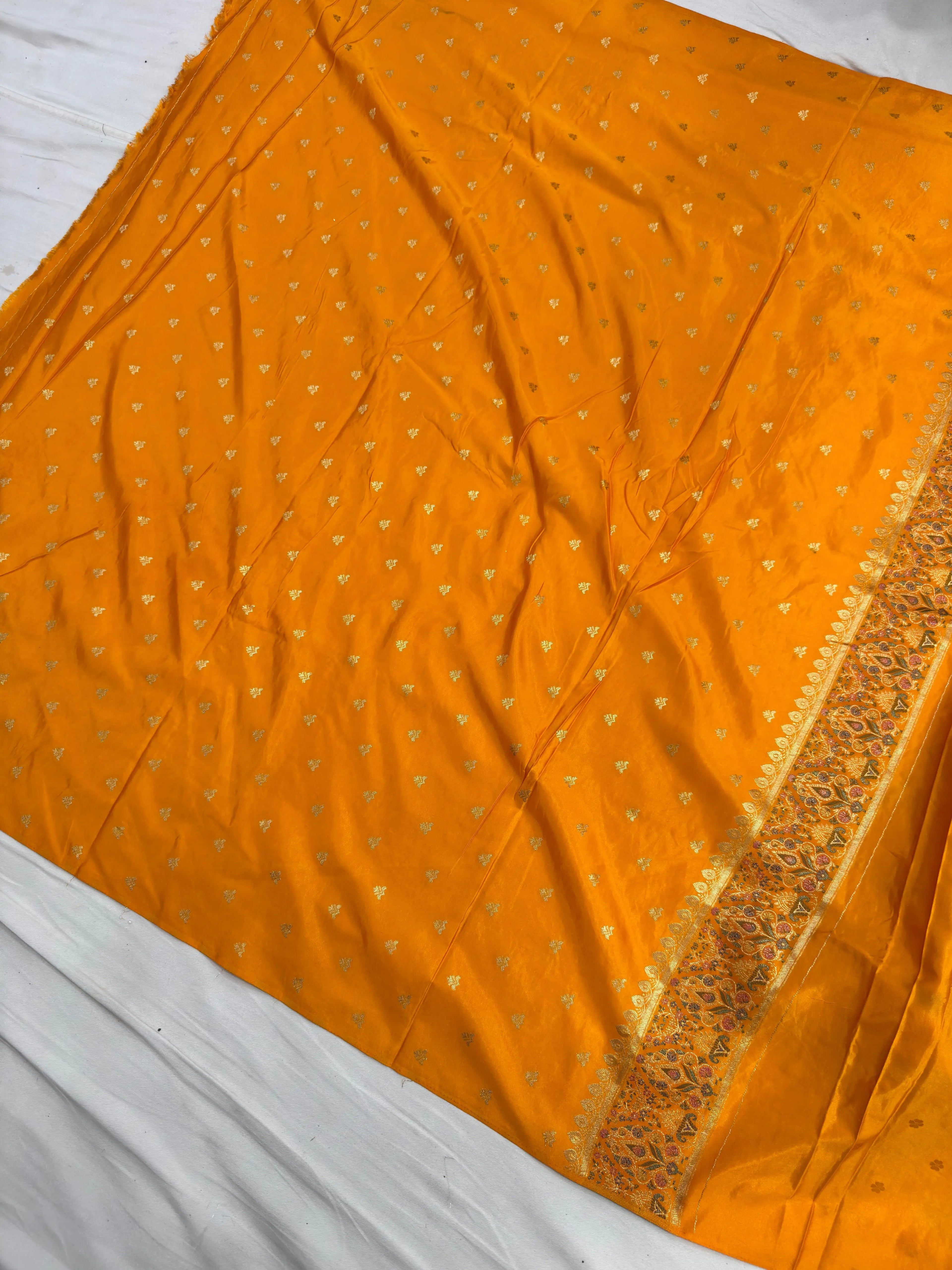 Orange fabric with gold patterns on a white background