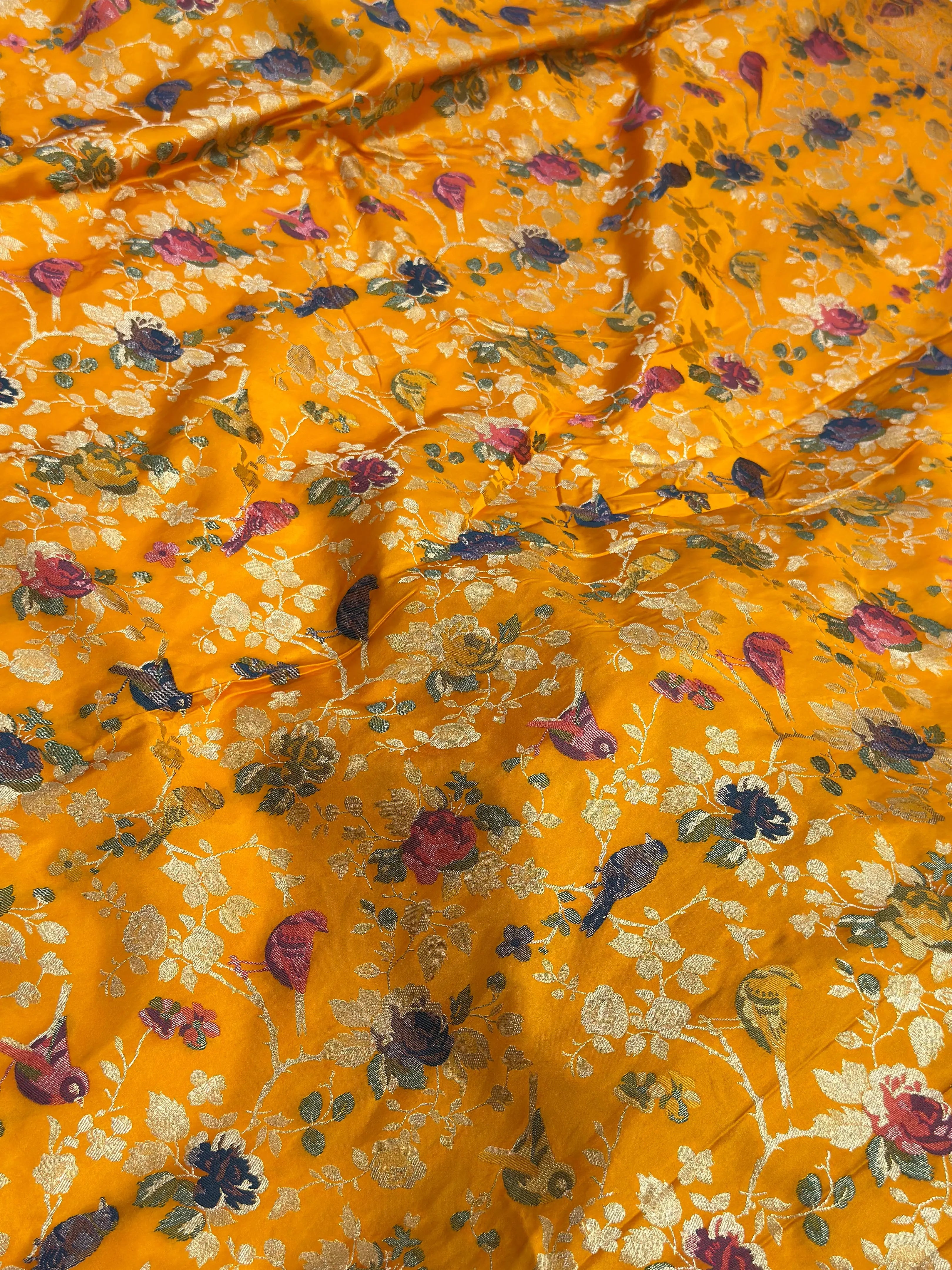 Floral patterned fabric with birds on a yellow background