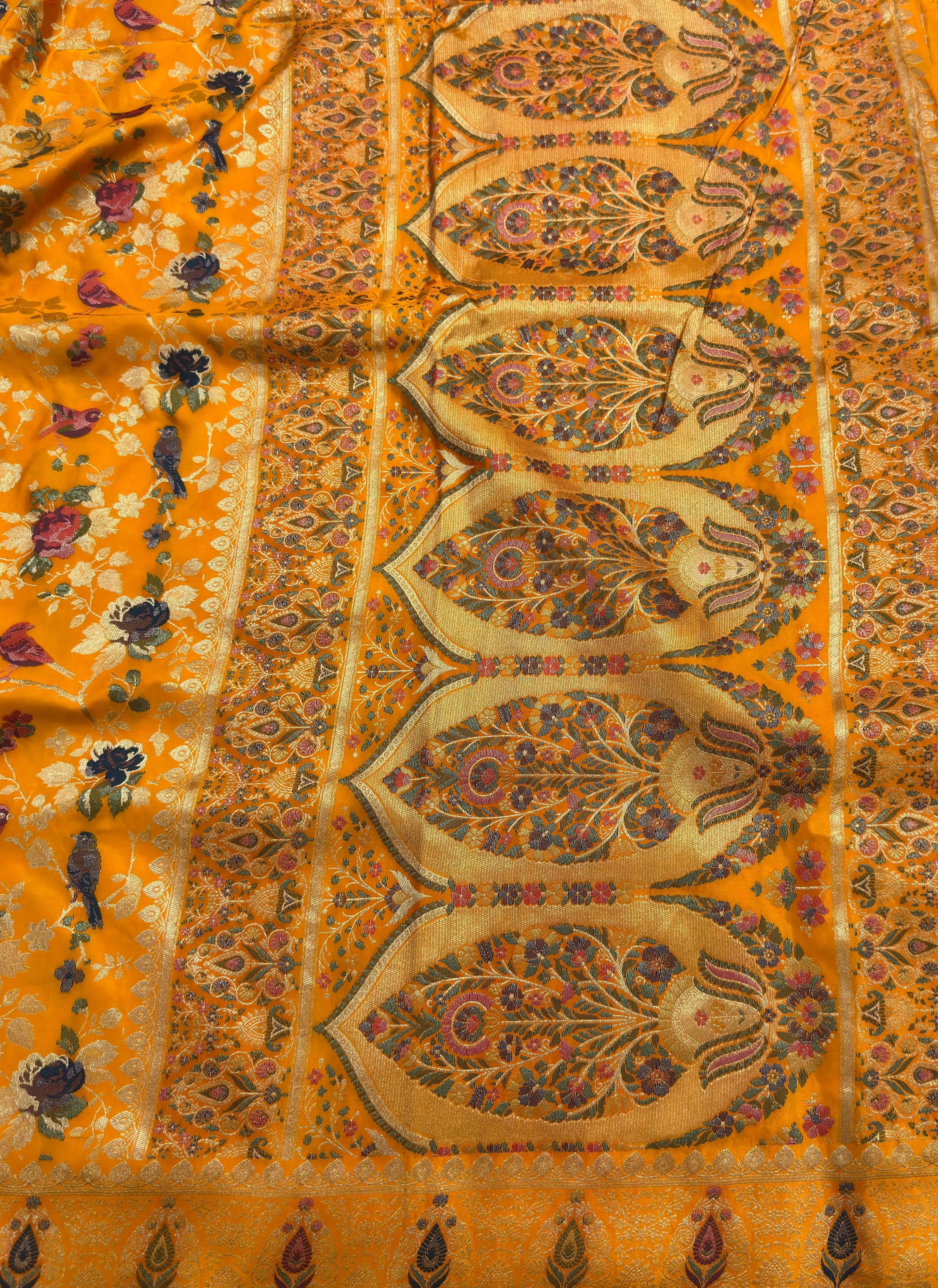 Close-up of a patterned fabric with intricate designs on a yellow background
