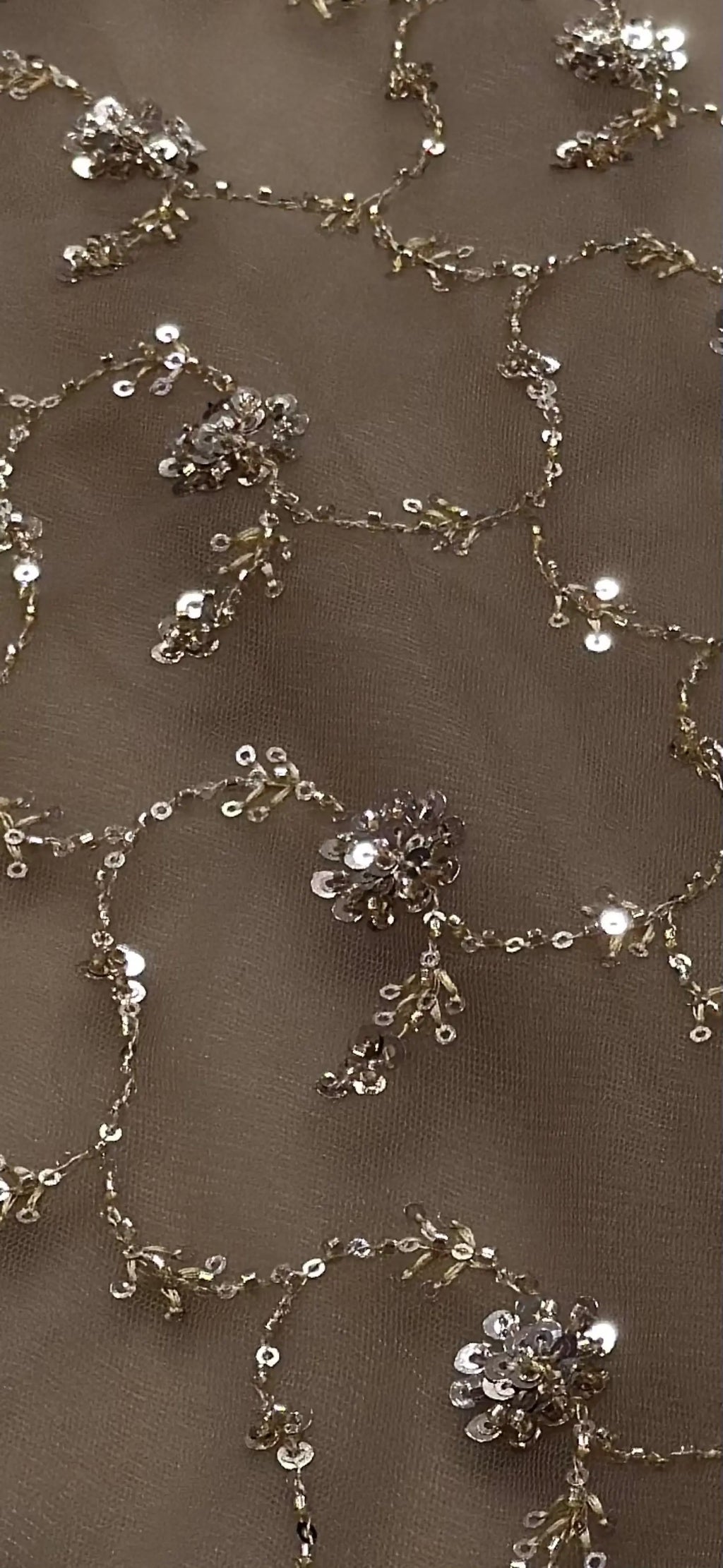 Close-up of decorative floral chain with crystals on a beige background
