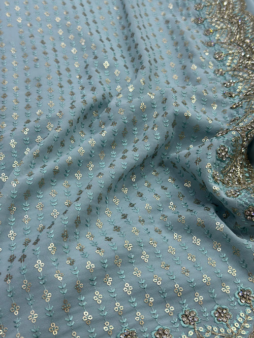 Close-up of blue fabric with gold floral patterns