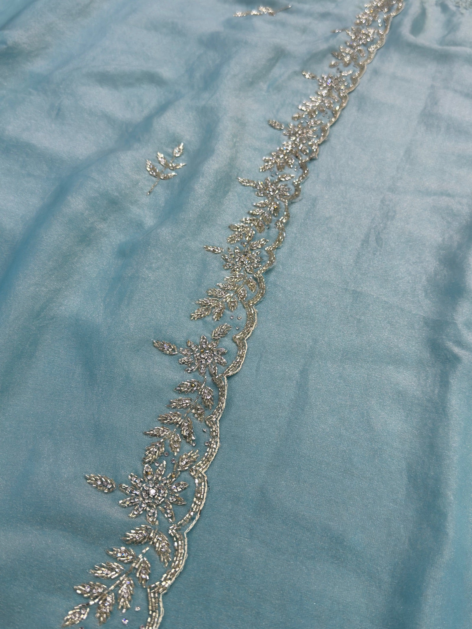 Decorative lace trim on a light blue fabric background