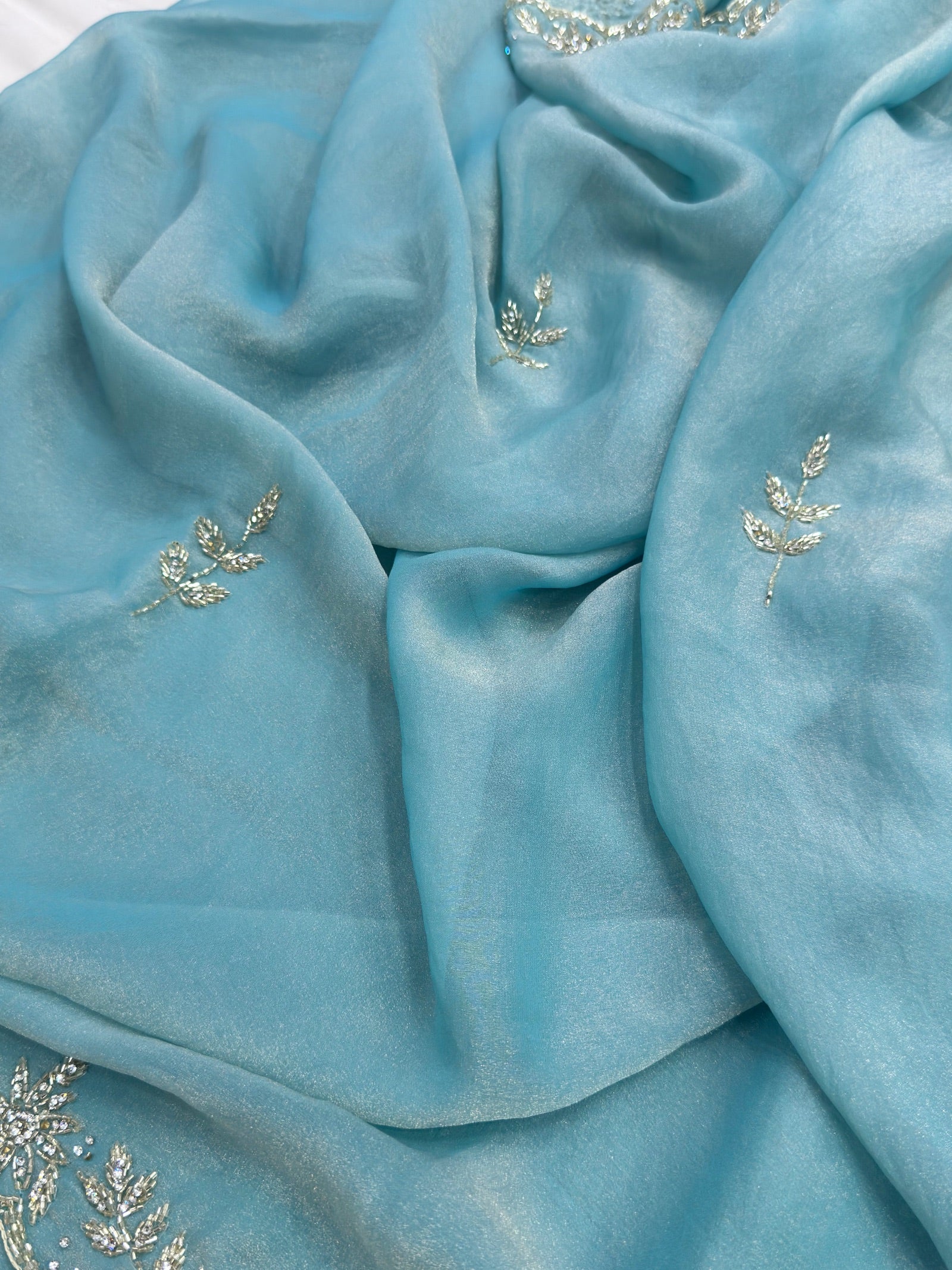 Close-up of a light blue fabric with floral embroidery