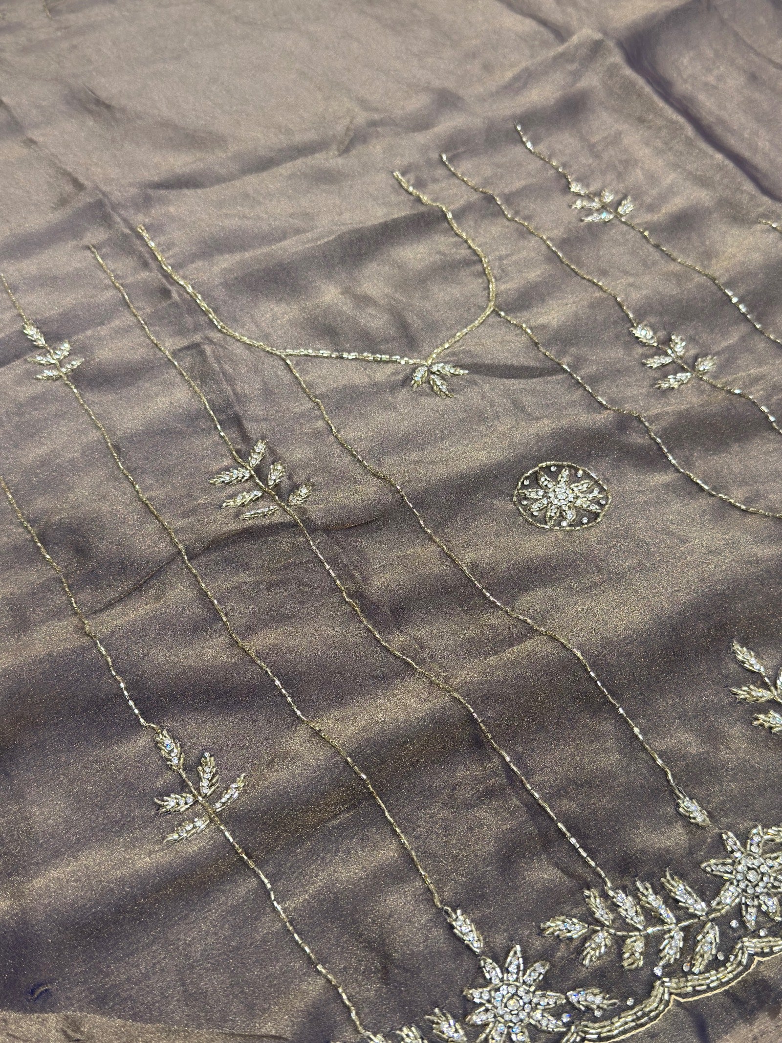 Dark fabric with intricate silver embroidery