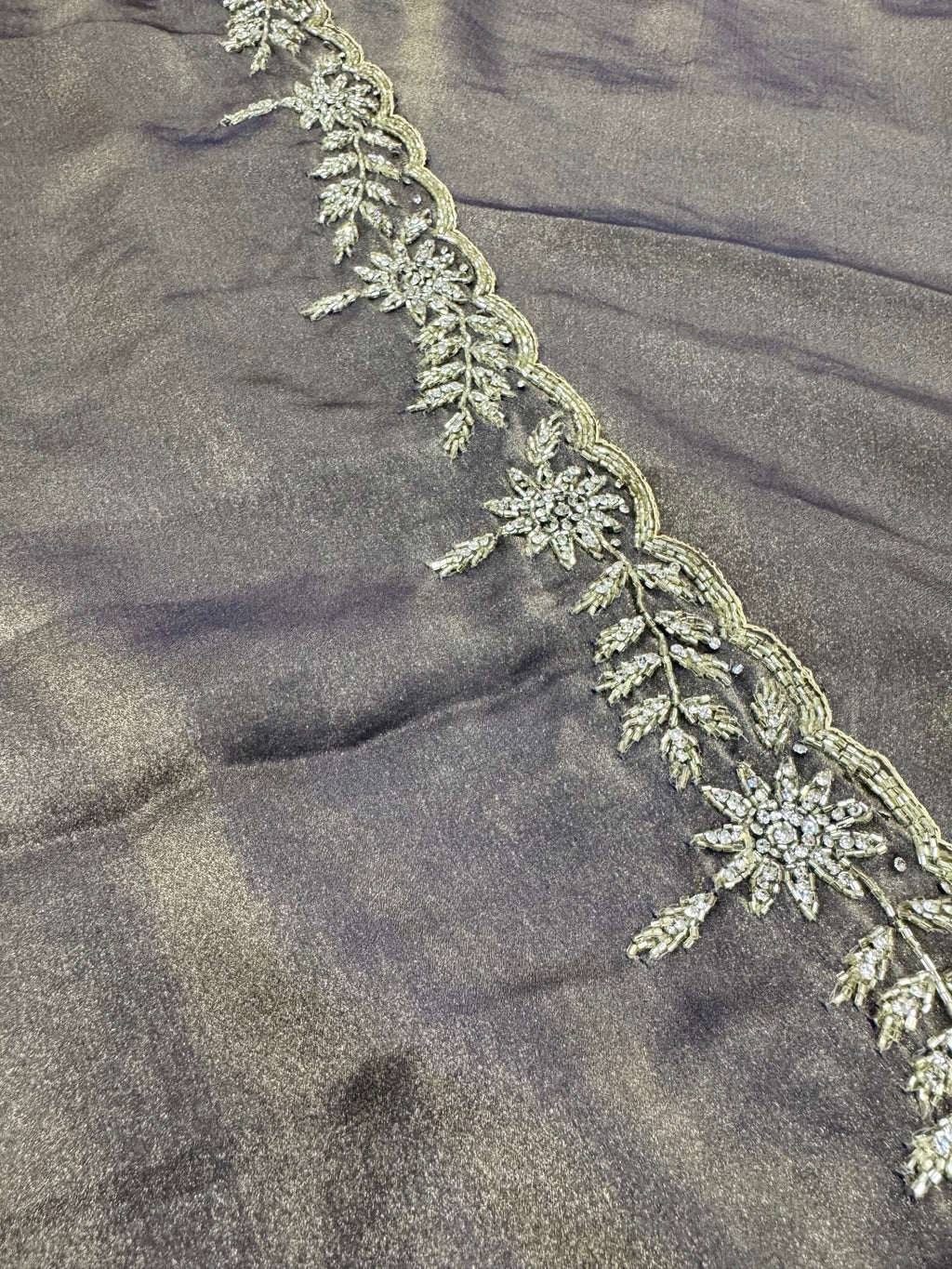 Decorative lace trim on a dark fabric background