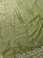 Green fabric with intricate silver embroidery