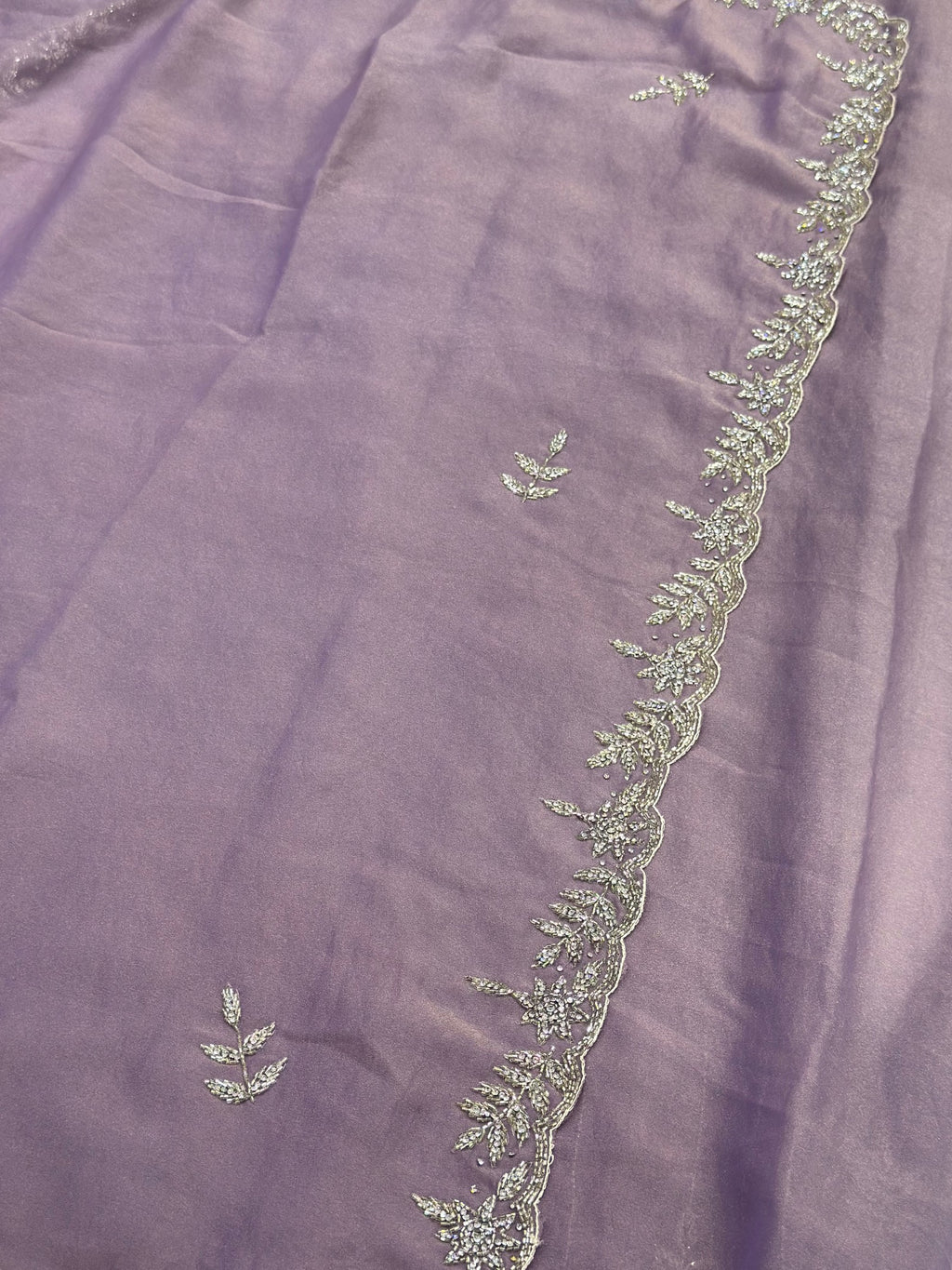 Embroidered fabric with floral patterns on a purple background