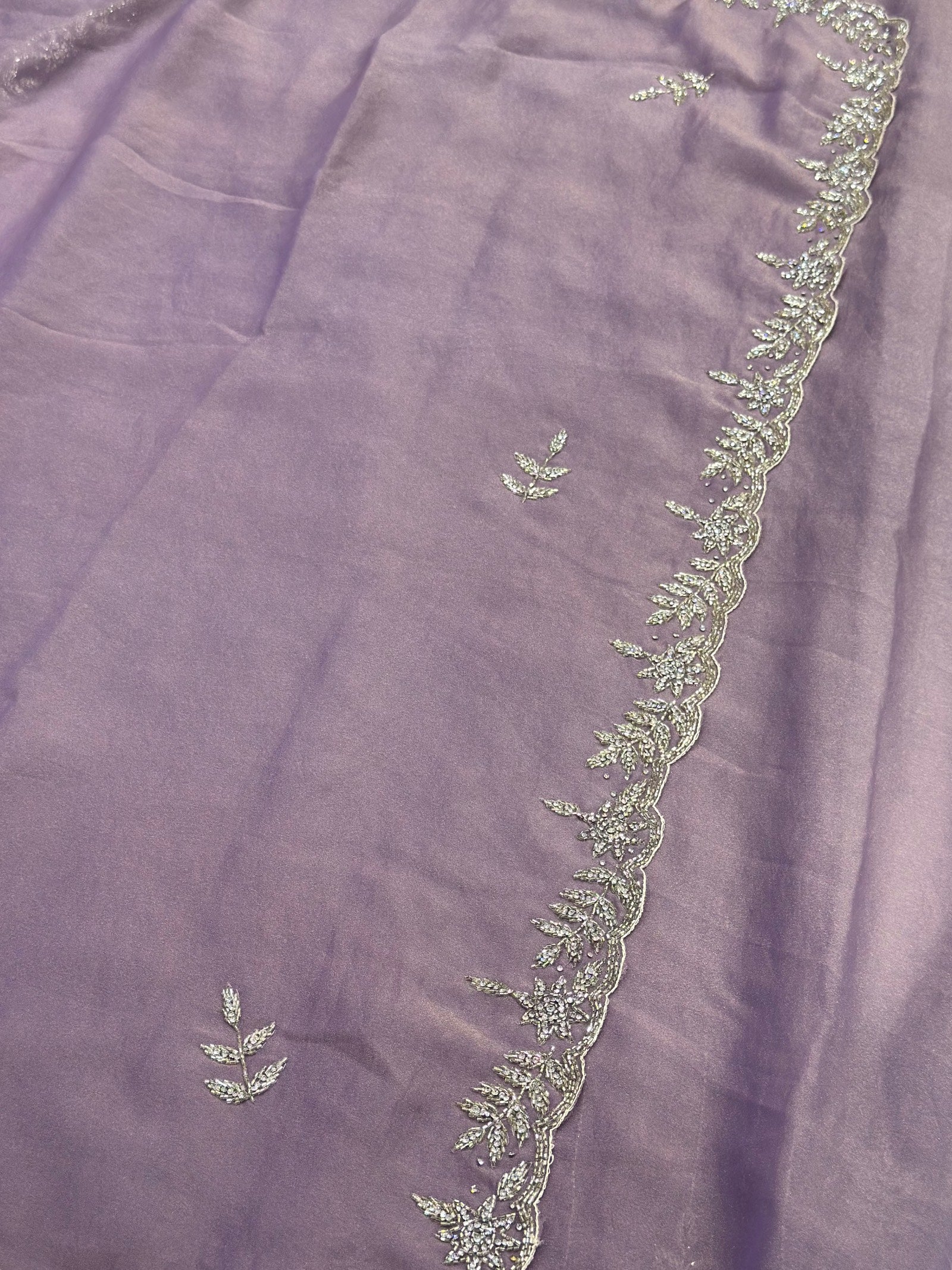 Embroidered fabric with floral patterns on a purple background