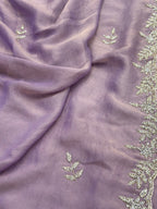 Purple fabric with green leaf-like embroidery