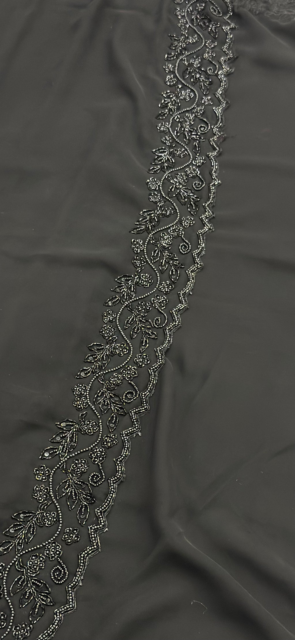Decorative lace trim on a dark fabric background