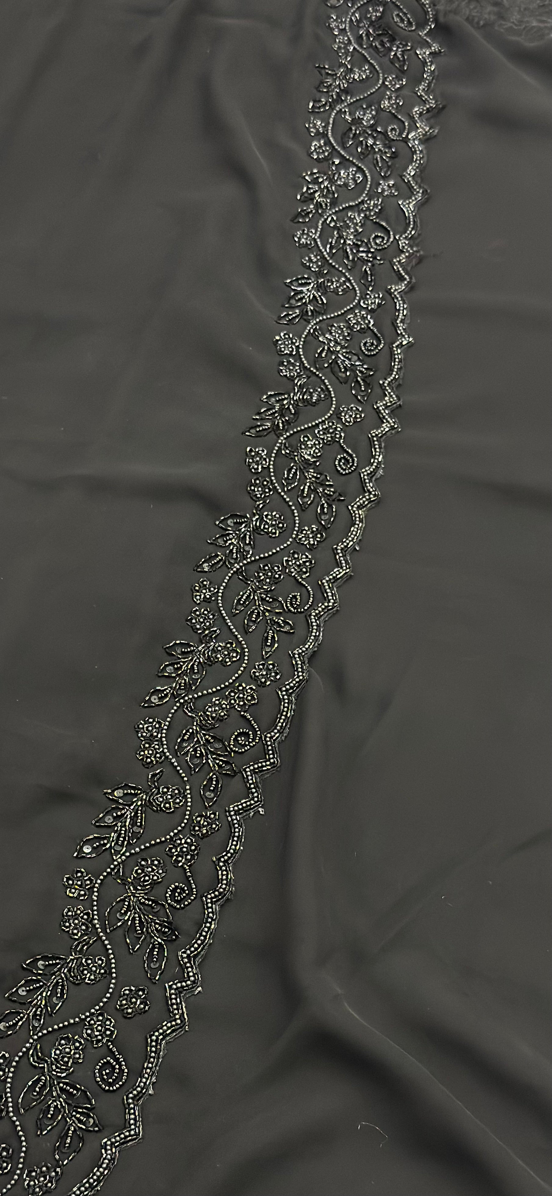 Decorative lace trim on a dark fabric background
